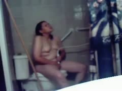Chubby amateur black haired nympho masturbates on the crapper bowl